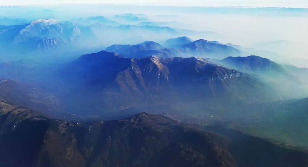 brown mountains under clouds