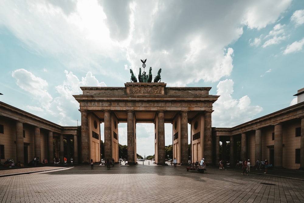 brown concrete gateway under white clouds