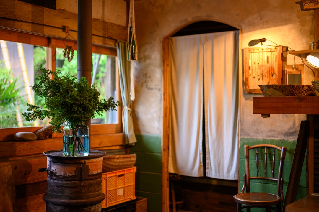 brown wooden chair beside white curtain