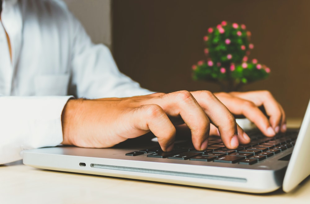 person using grey laptop computer