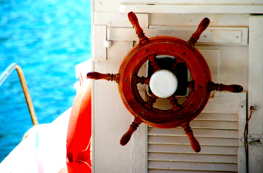 a close up of a ship's steering wheel on a boat