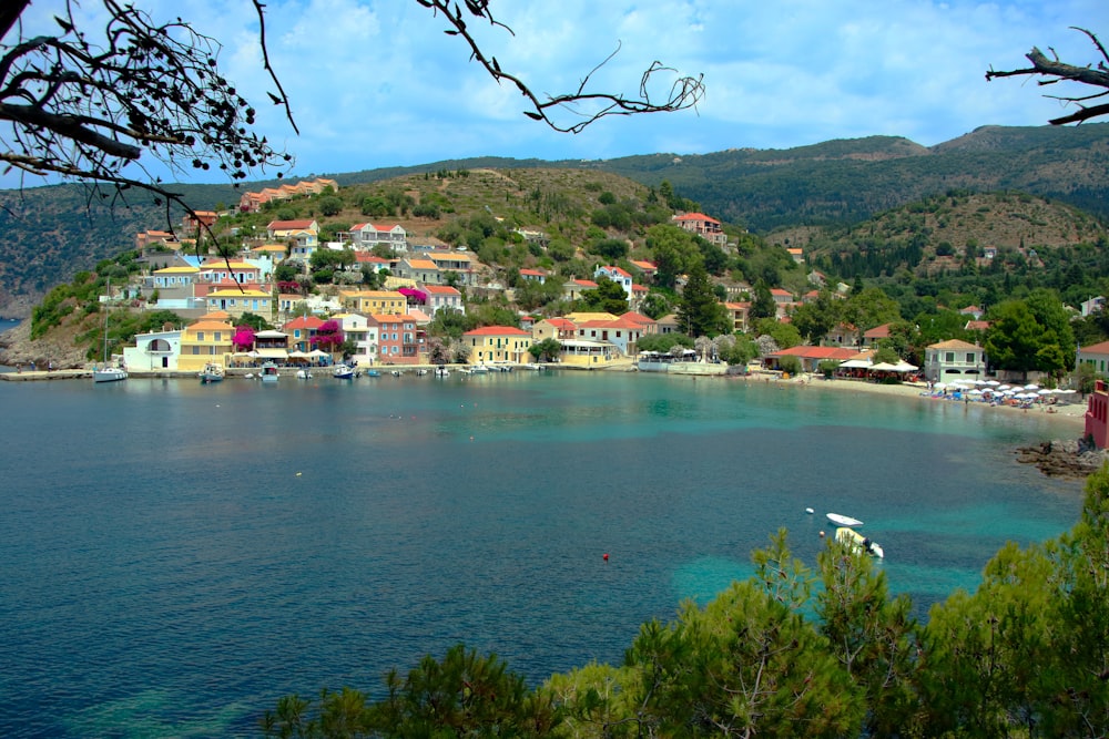 a small village on a hill above a body of water