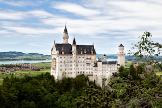white concrete building near trees during daytime