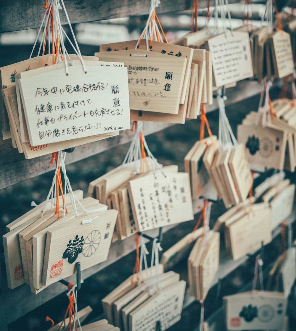 a bunch of wooden signs hanging from a wall