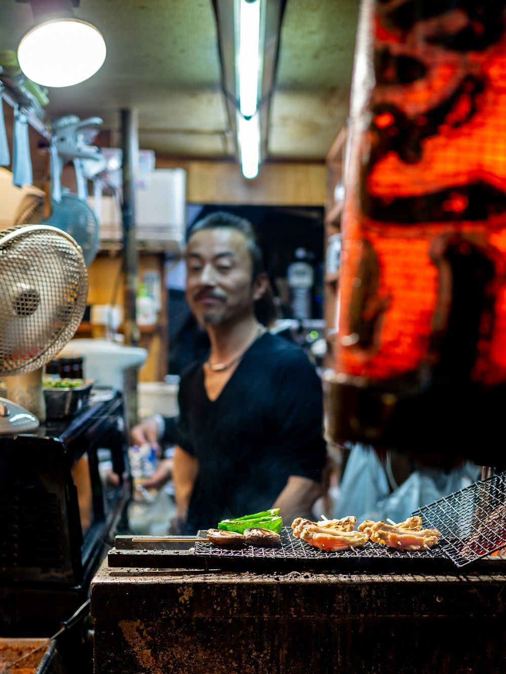 a man standing in a kitchen preparing food