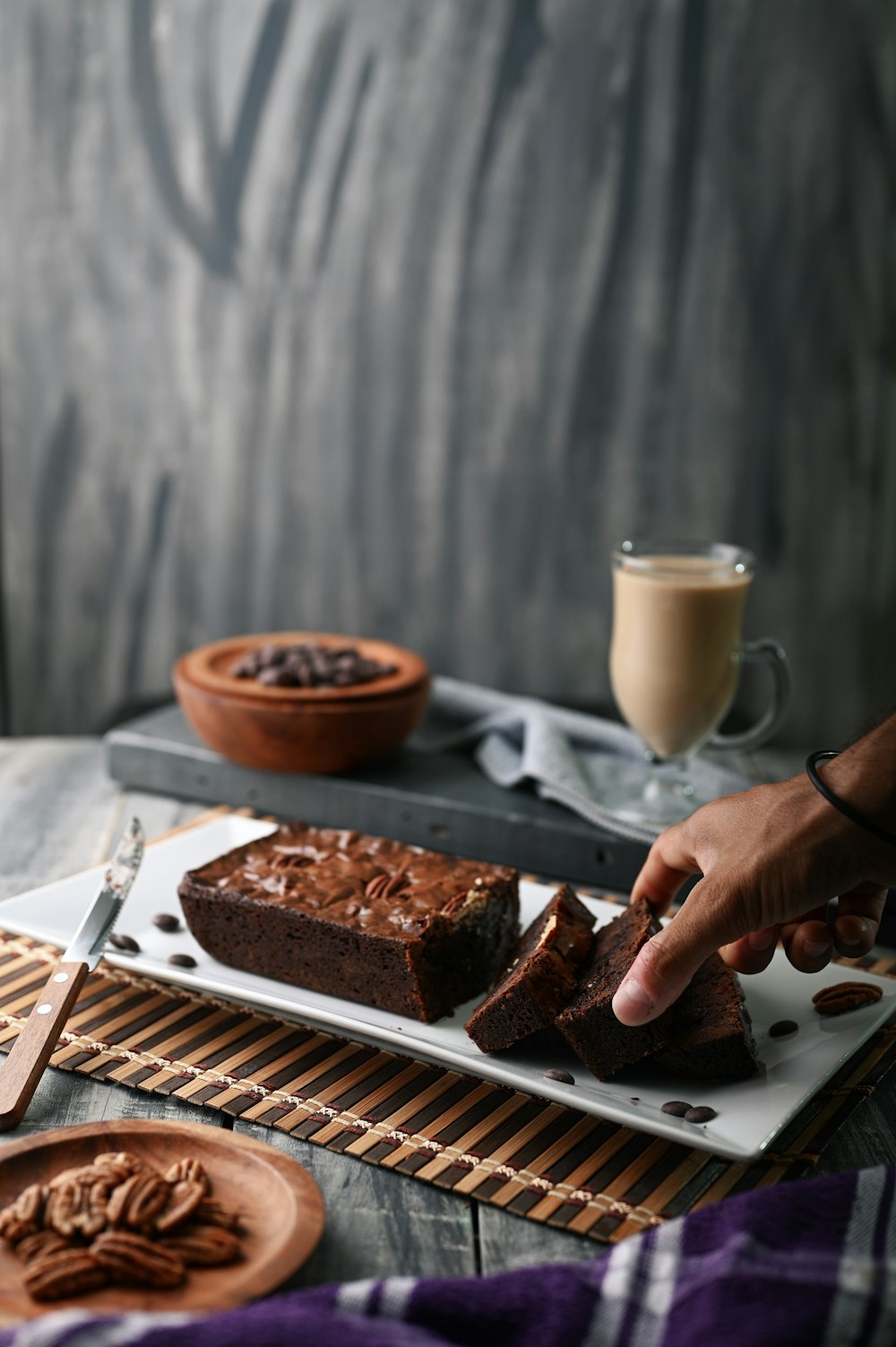 person holding cakes on tray]