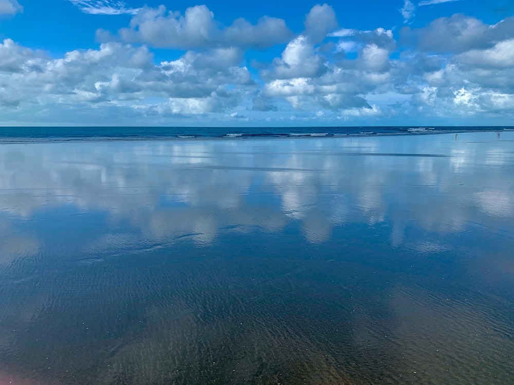 body of water and clouds during daytime