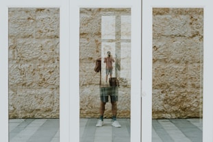 person near white framed glass door close-up photography