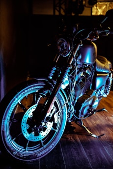 A sleek motorcycle parked in a sunlit garage, showcasing shiny chrome details.