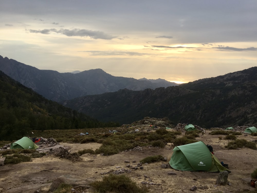 people near tents on mountain