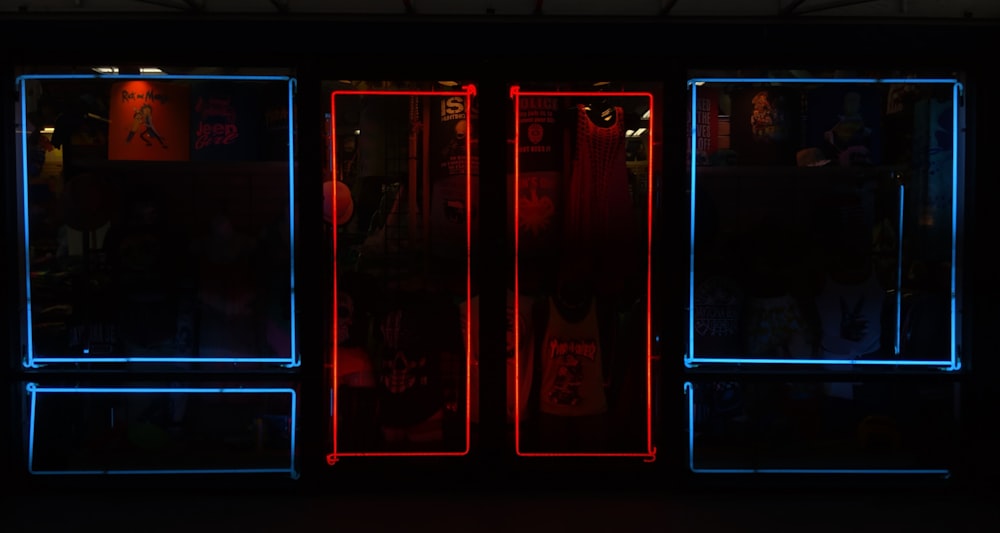a dark room with neon lights and a red and blue door