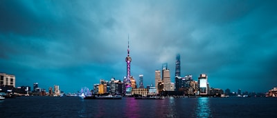 A city skyline at dusk illuminated by interconnected digital cloud icons representing secure data flow.