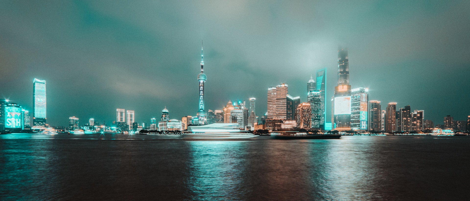 A dark and moody image of an abstract city skyline illuminated by neon lights, reflecting the urban atmosphere of arkkay's music.