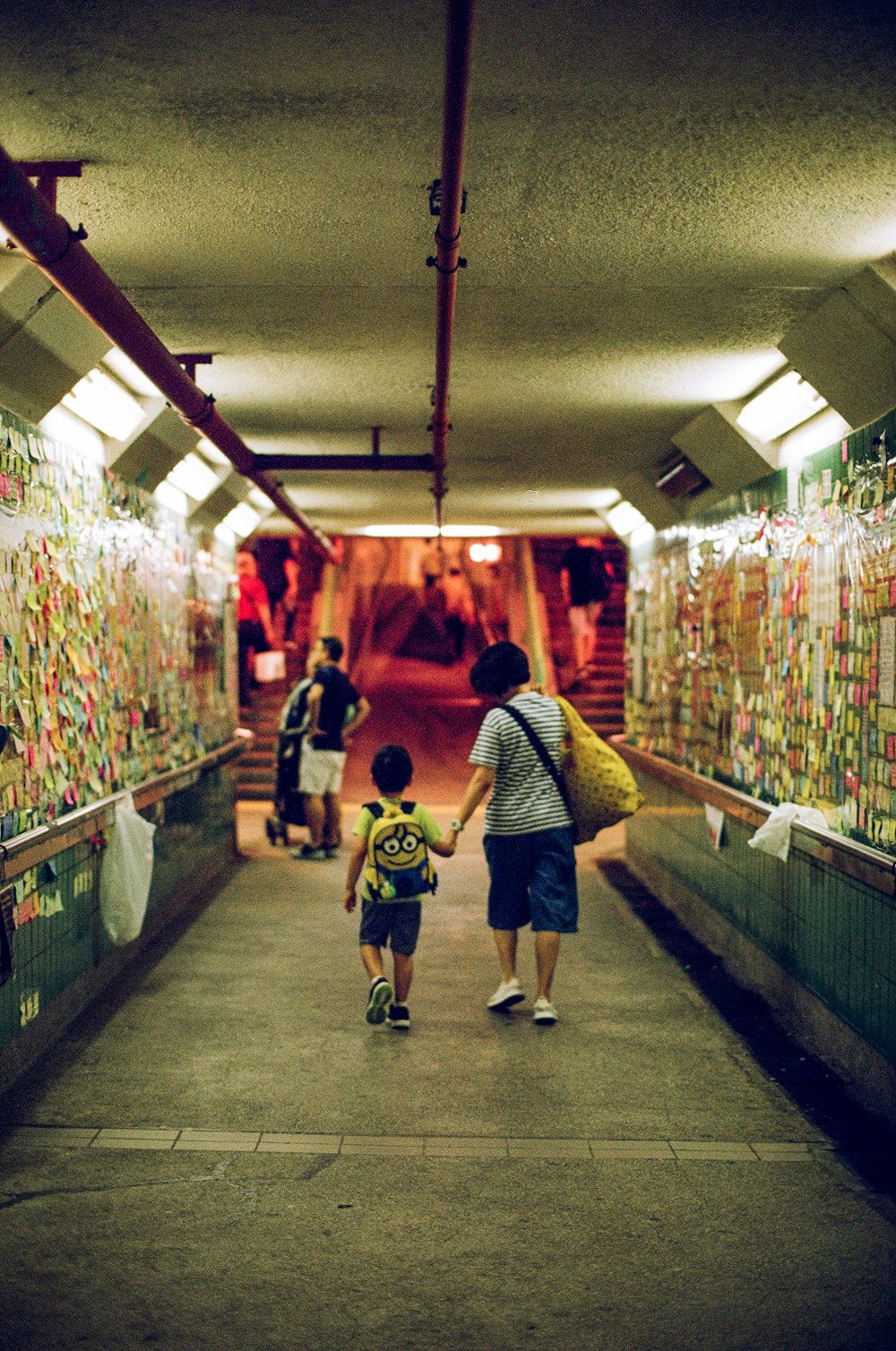 people walking in tunnel