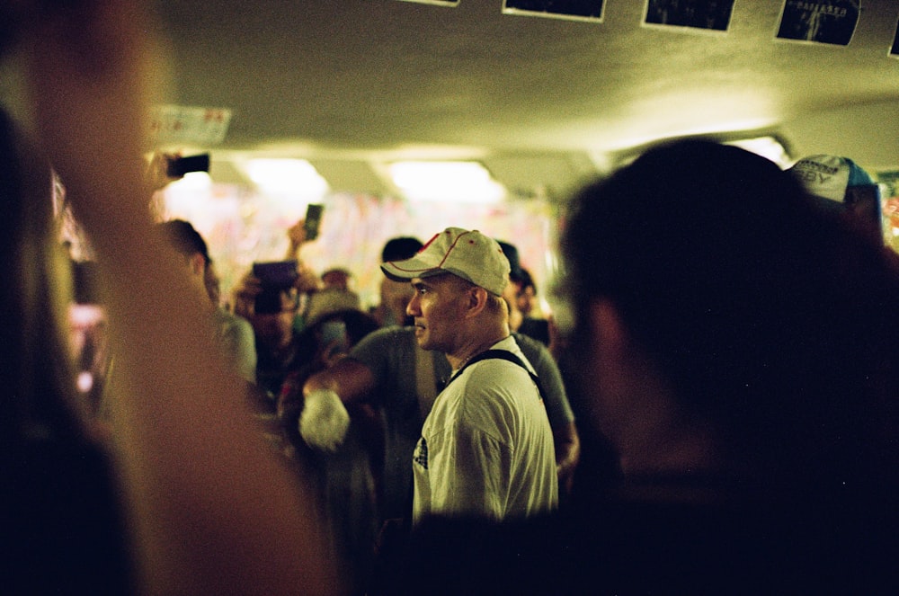 man wearing white shirt and white baseball cap