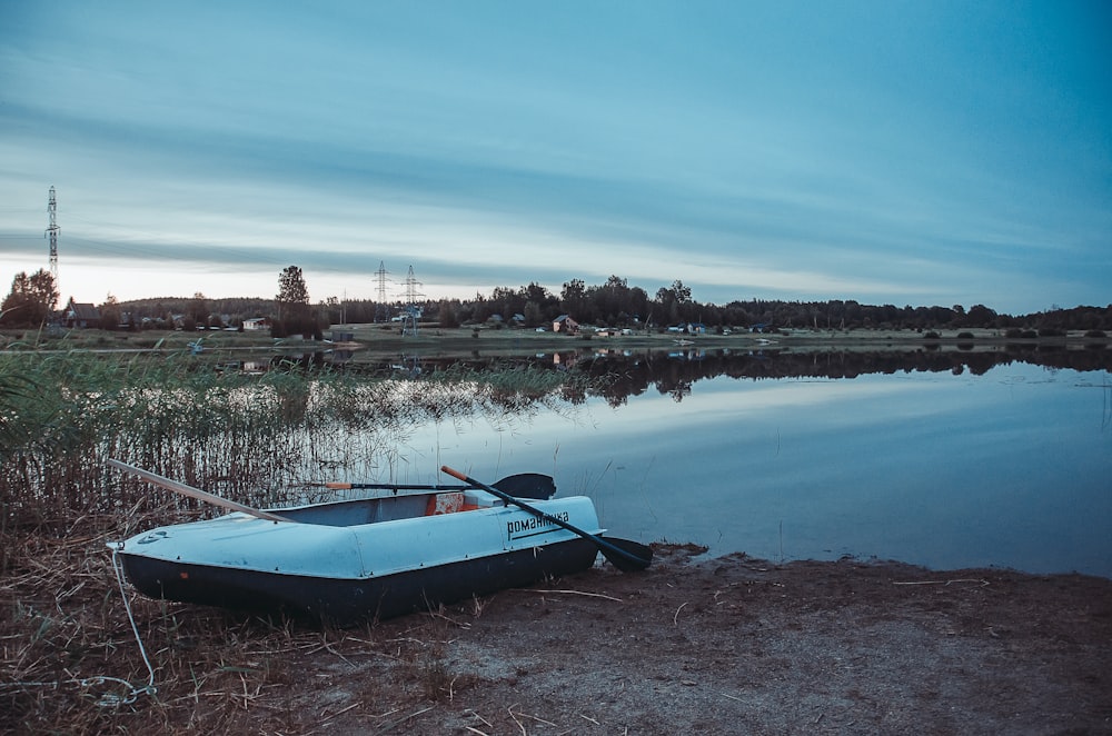 white boat near body of water during daytime