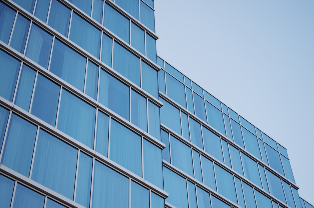 a tall blue building with lots of windows