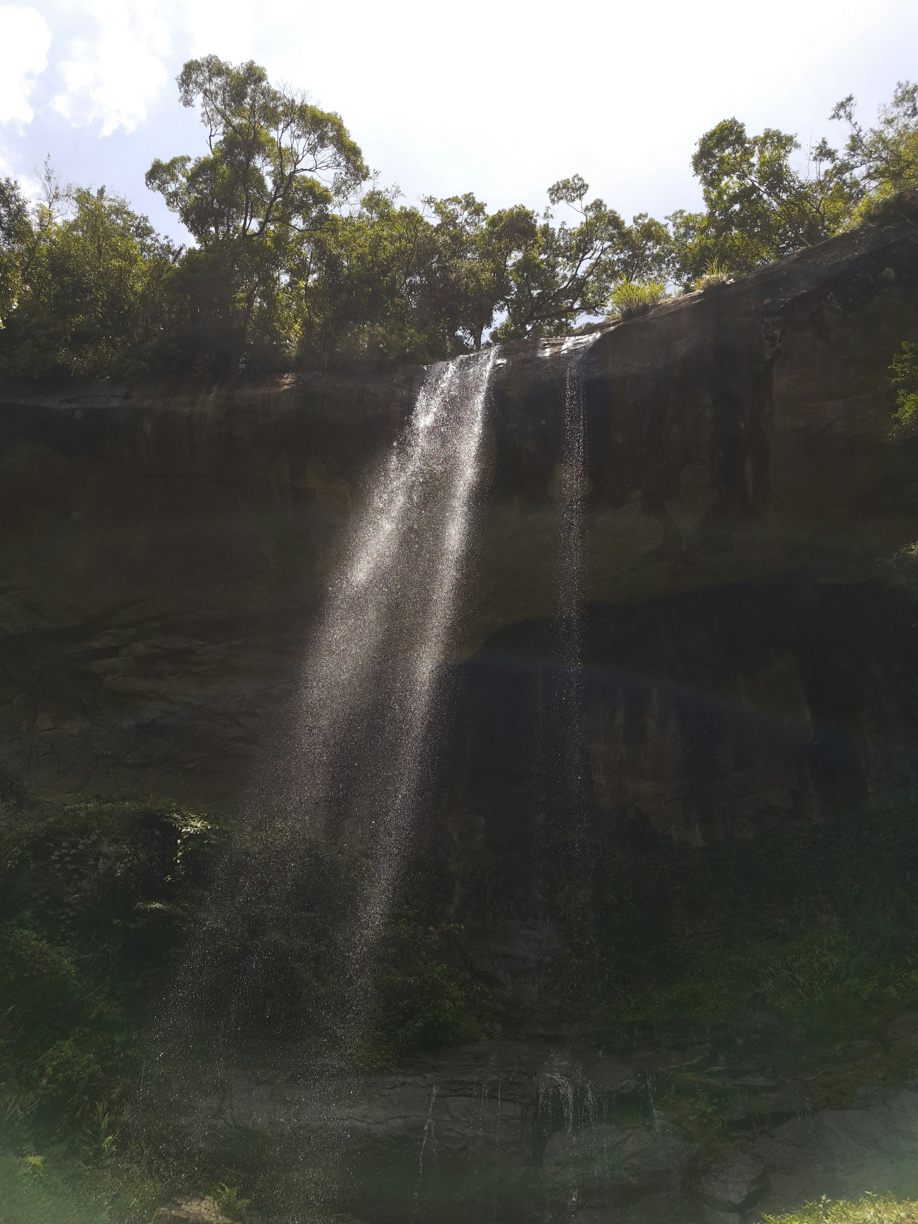 a large waterfall falling down into a body of water