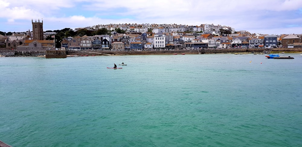 body of water near buildings at daytime