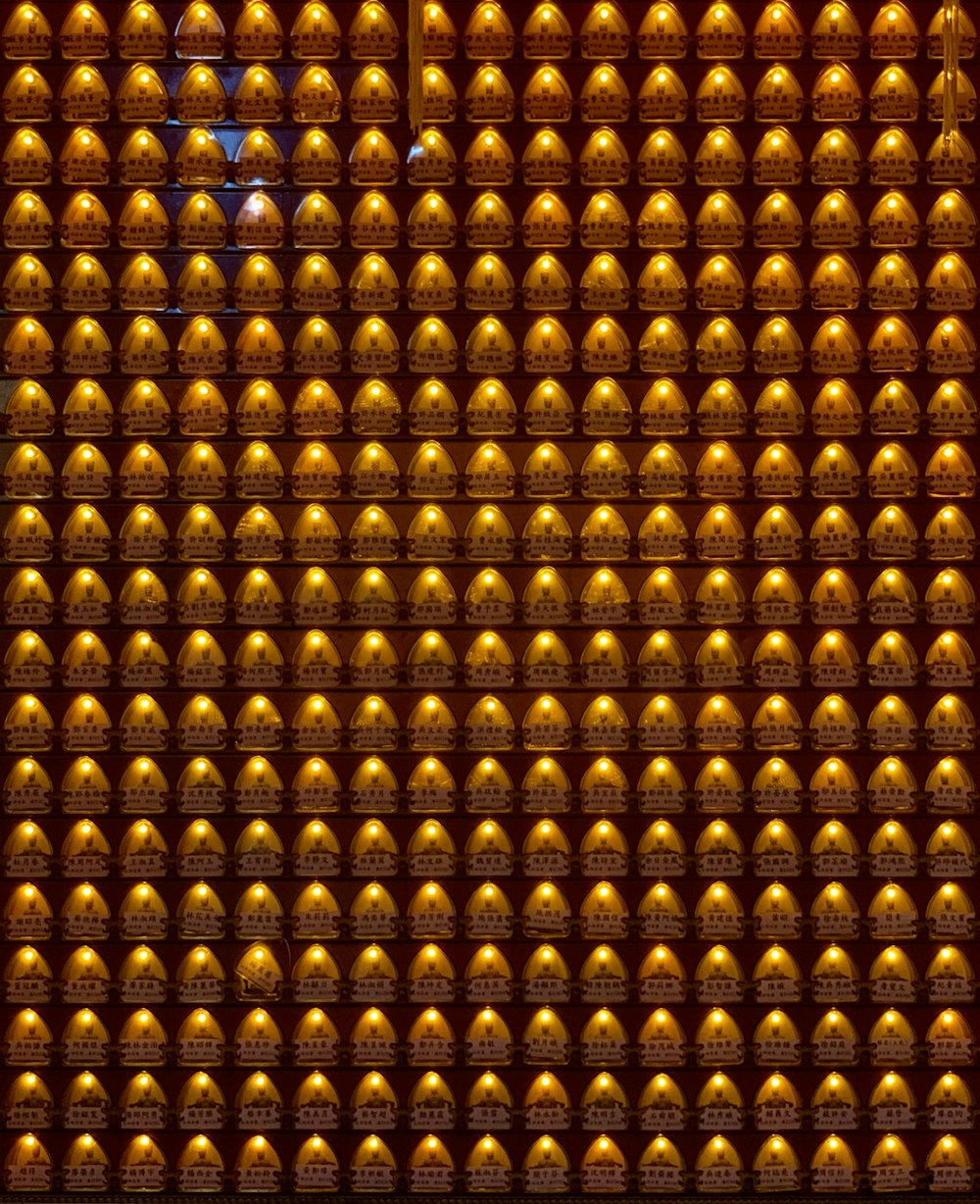 a wall of gold bells in a building