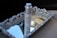 A bottle of skincare product labeled 'EQUILIBRIUM' stands on an ornate silver tray with decorative carvings, positioned on a car seat. The tray reflects parts of the interior, creating a luxurious and sophisticated arrangement.