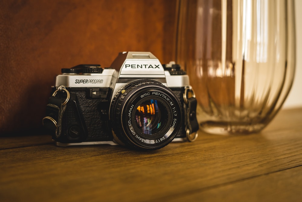 closeup photo of black and gray Pentax DSLR camera