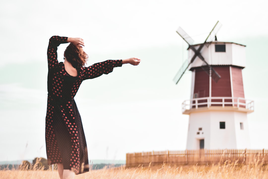 woman walking near windmill