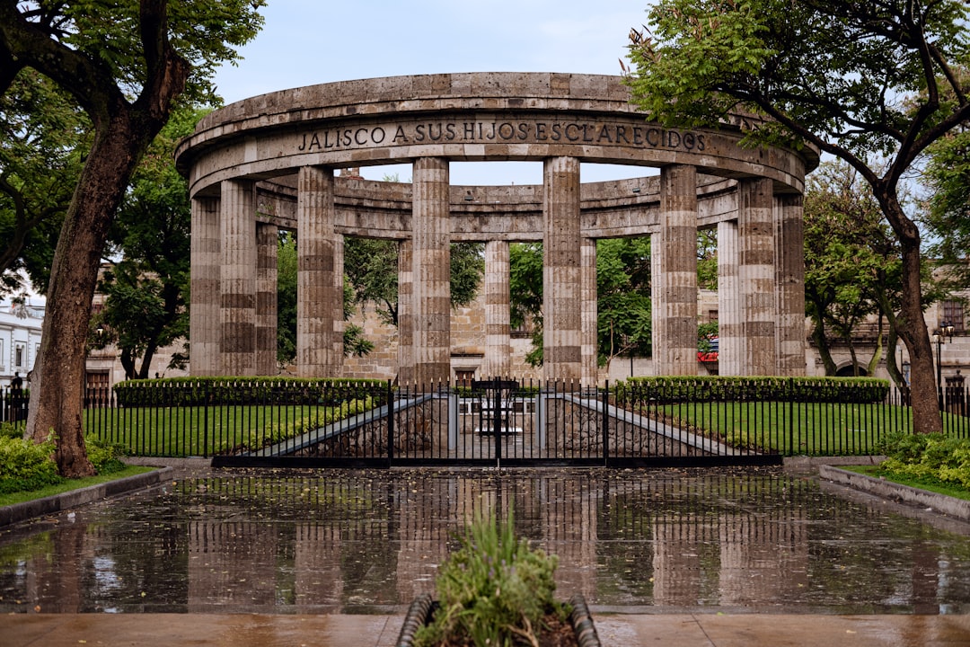 brown memorial near trees, Rotonda de los Jaliscienses Ilustres<p></figure>