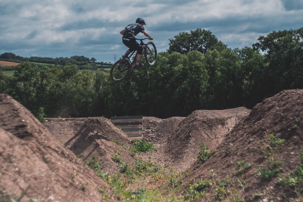 biker doing stunts on hills