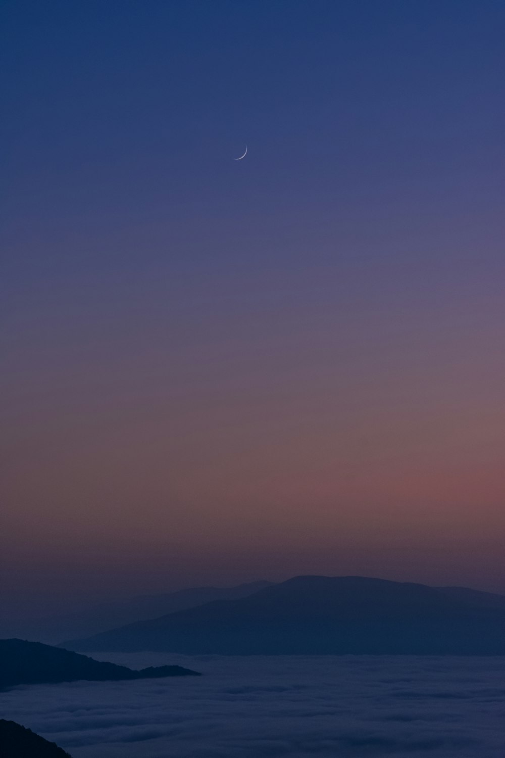 mountain near river during fog