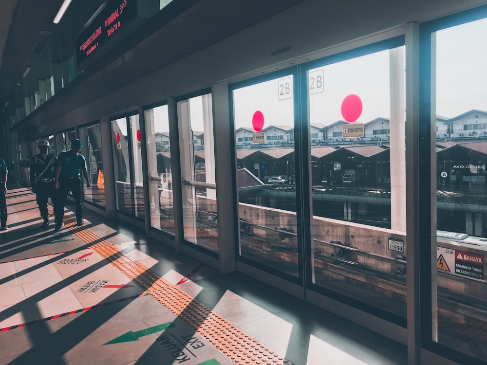 people walking near window during daytime