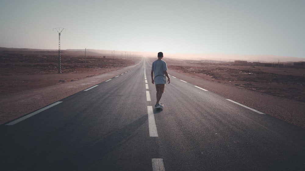 man skating on empty road