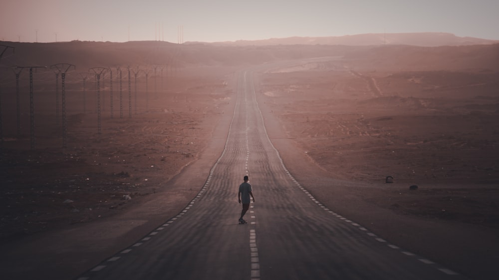 man walking on empty road
