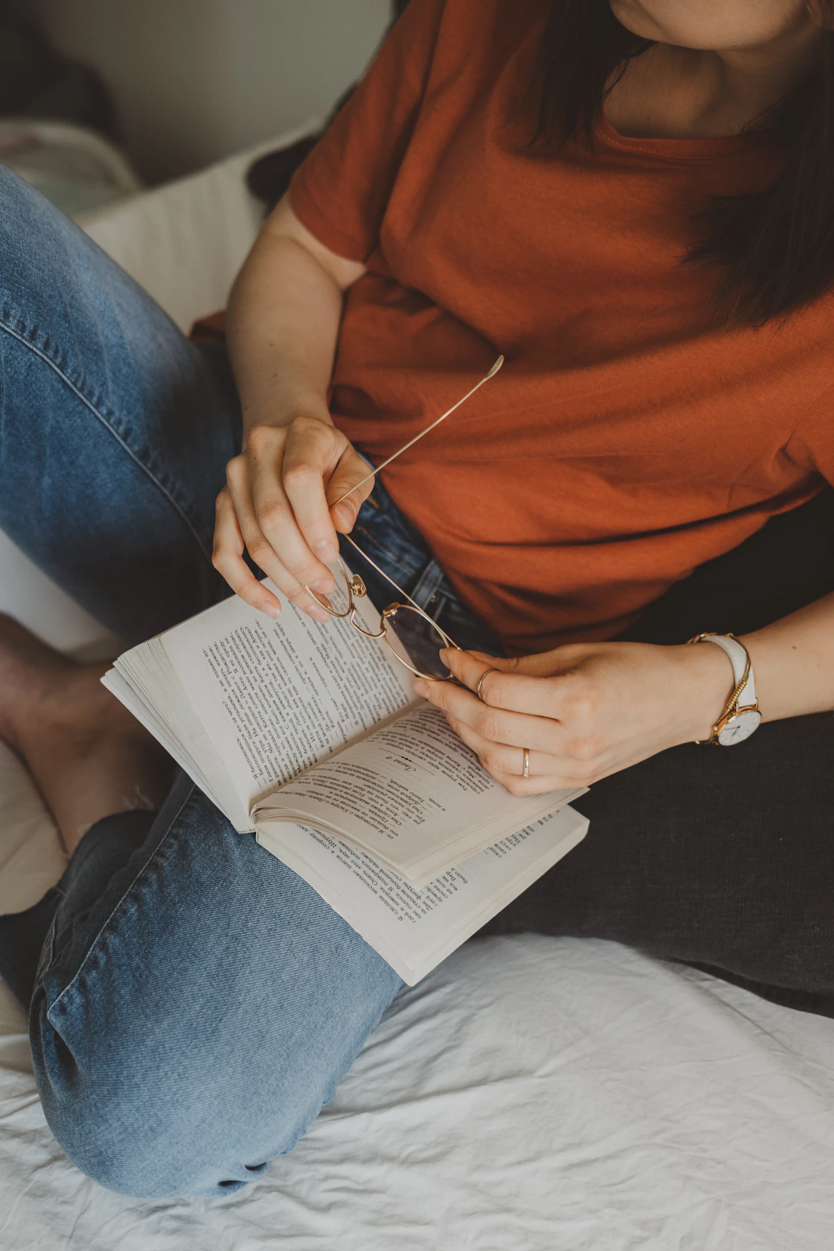 A woman relaxing and reading a book in a cozy room