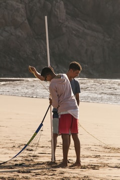 Close-up of hands setting up a volleyball net with precision.
