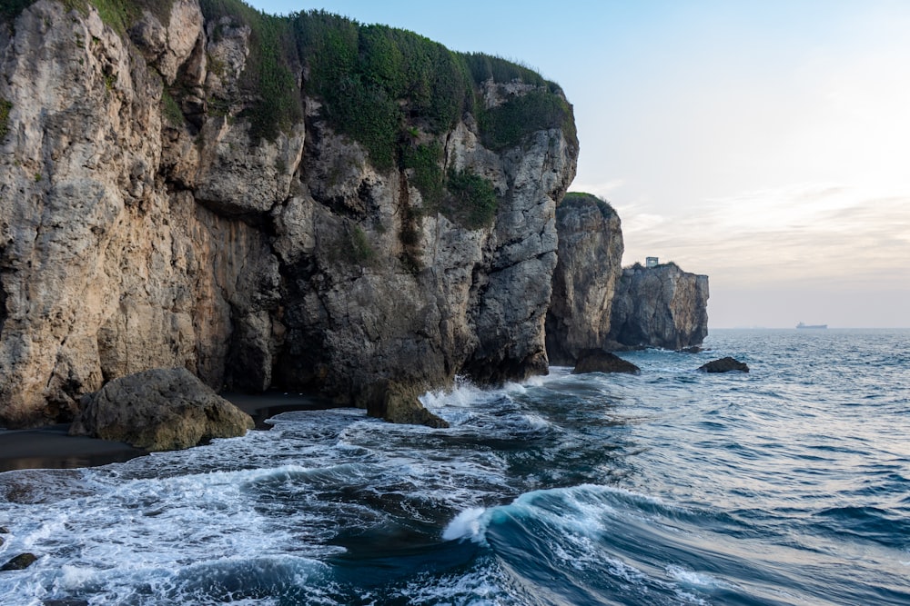 cliff near body of water at daytime