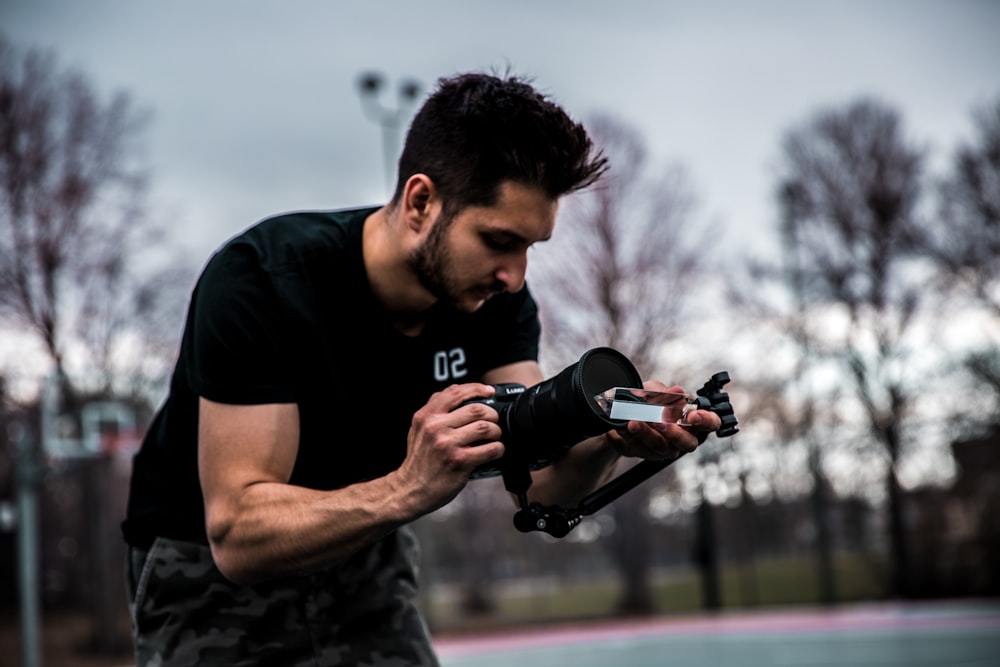 man holding DSLR camera