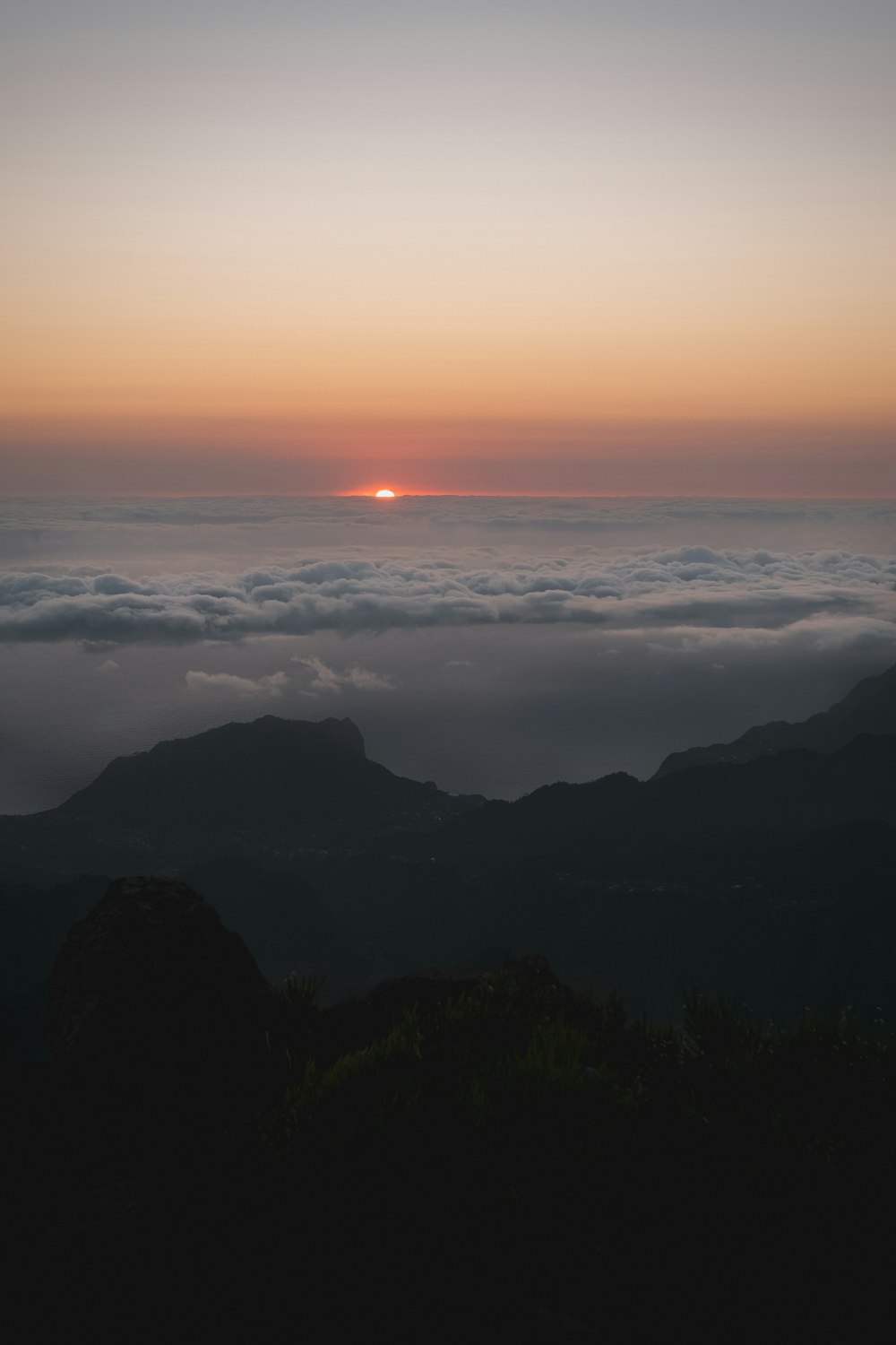 landscape photo of black mountain range under fogs