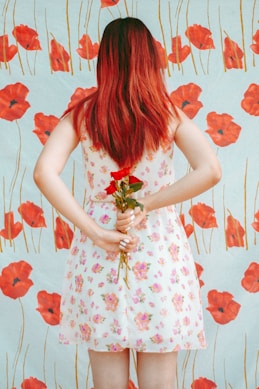 woman hides red roses from her back