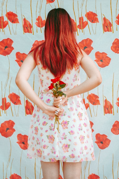 woman hides red roses from her back
