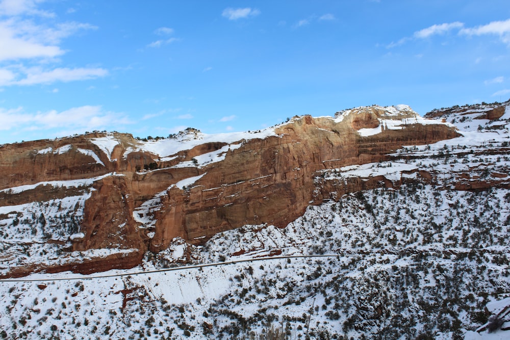 a scenic view of a mountain with snow on the ground