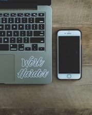 A person wearing a shirt with the slogan 'Work smarter not harder!!' while working on a tablet.