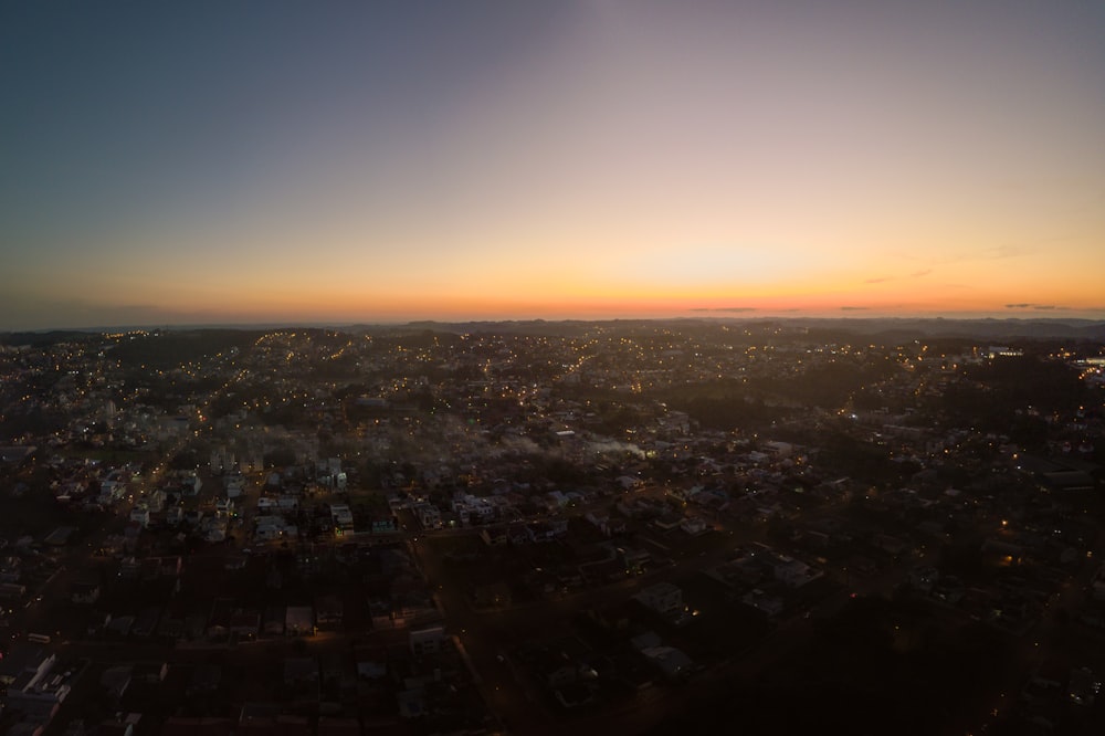 the sun is setting over a city in the distance