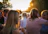 A peaceful outdoor scene with a small group gathered around Meagan during a sunset retreat.