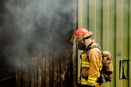 House with smoke indicating fire risk, highlighting the importance of homeowners insurance.