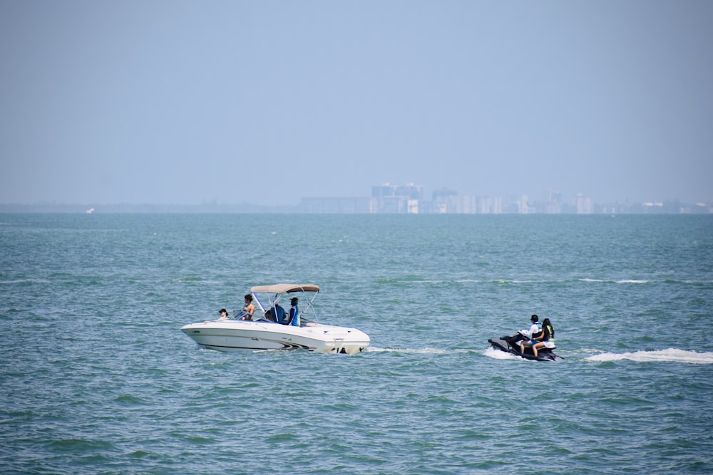 a group of people riding on the back of a white boat