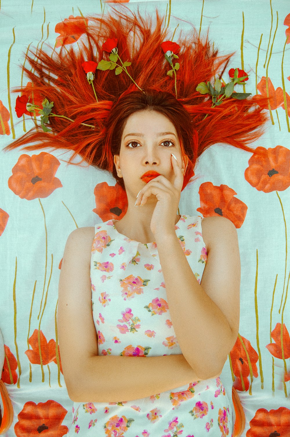 woman leaning on floral wall