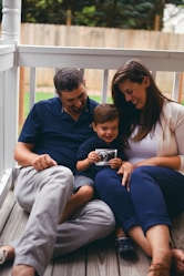 boy between man and woman during daytime