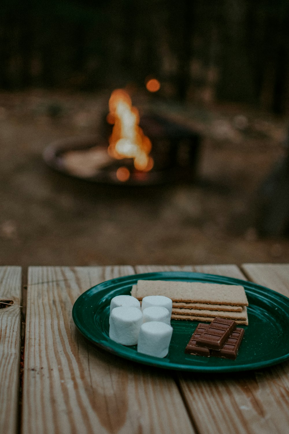 crackers and chocolates in round green ceramic plate