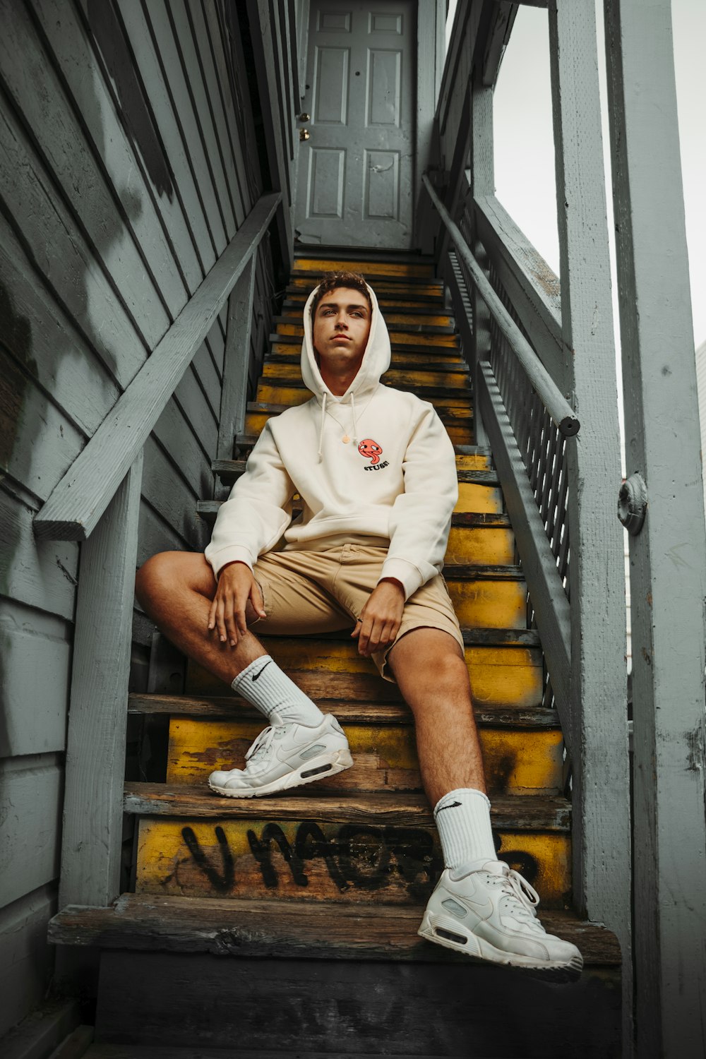 man sitting on wooden stairs